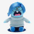 Once Upon Magic blue plush Sadness character from Disney Pixar's Inside Out, wearing a light blue knitted sweater and dark blue pants.