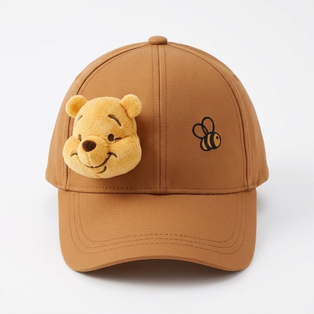 Once Upon Magic brown cotton baseball cap with 3D Winnie the Pooh face and embroidered bee detail.