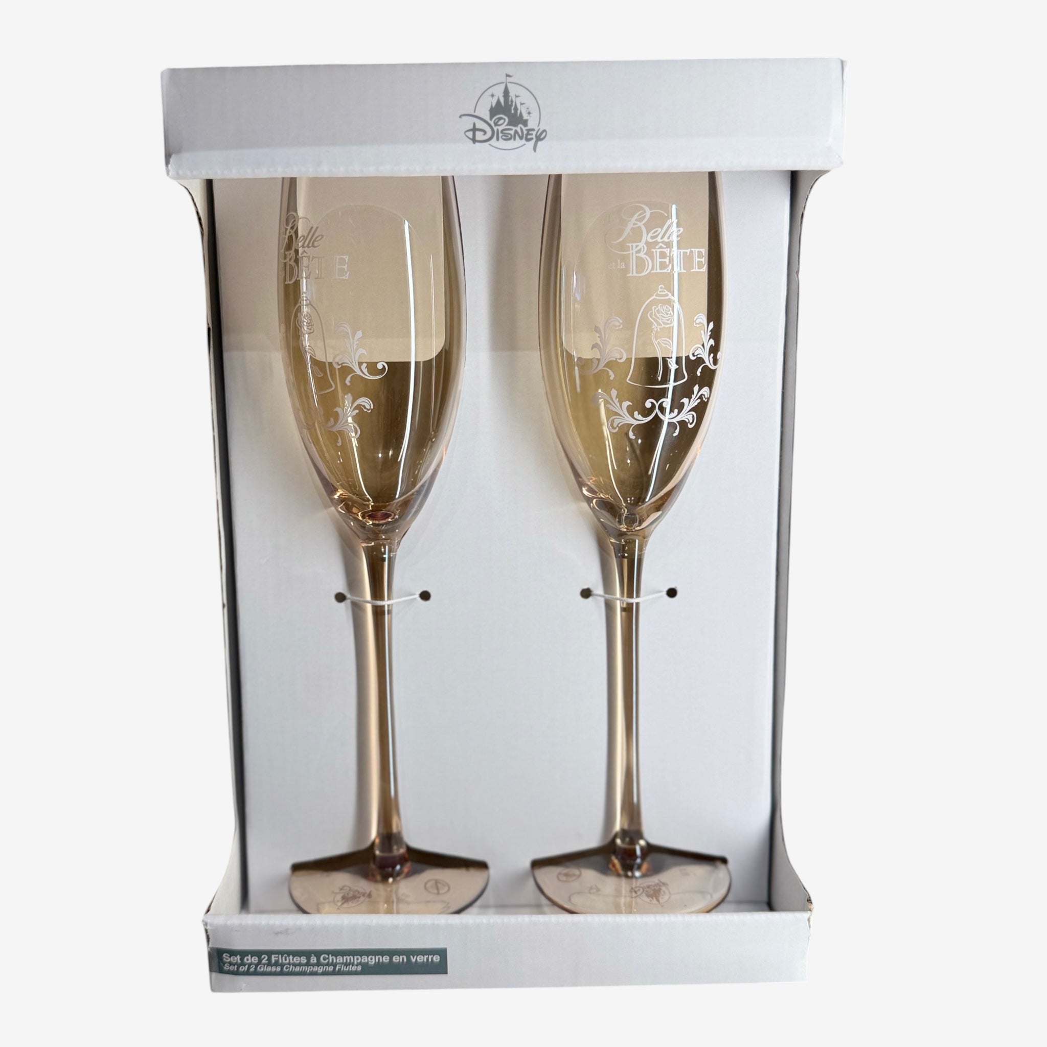 Once Upon Magic set of 2 champagne flutes in champagne gold glass with delicate rose and 'La Belle et la Bête' etching.