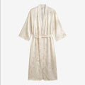 Once Upon Magic cream satin kimono robe with subtle Disney character and floral print, belted waist, short sleeves.