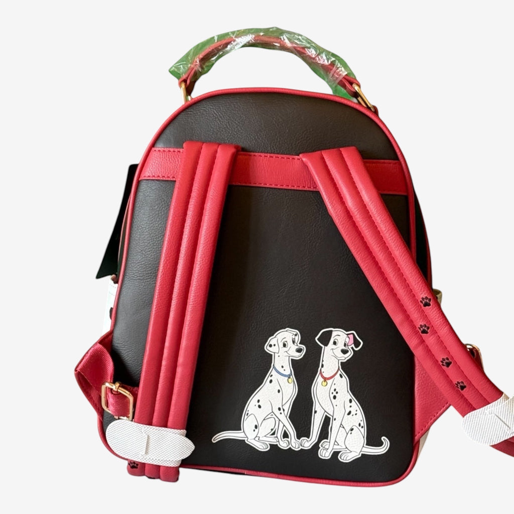 Once Upon Magic black faux leather backpack with red trim, featuring two Dalmatians and paw print accents. Includes adjustable straps.