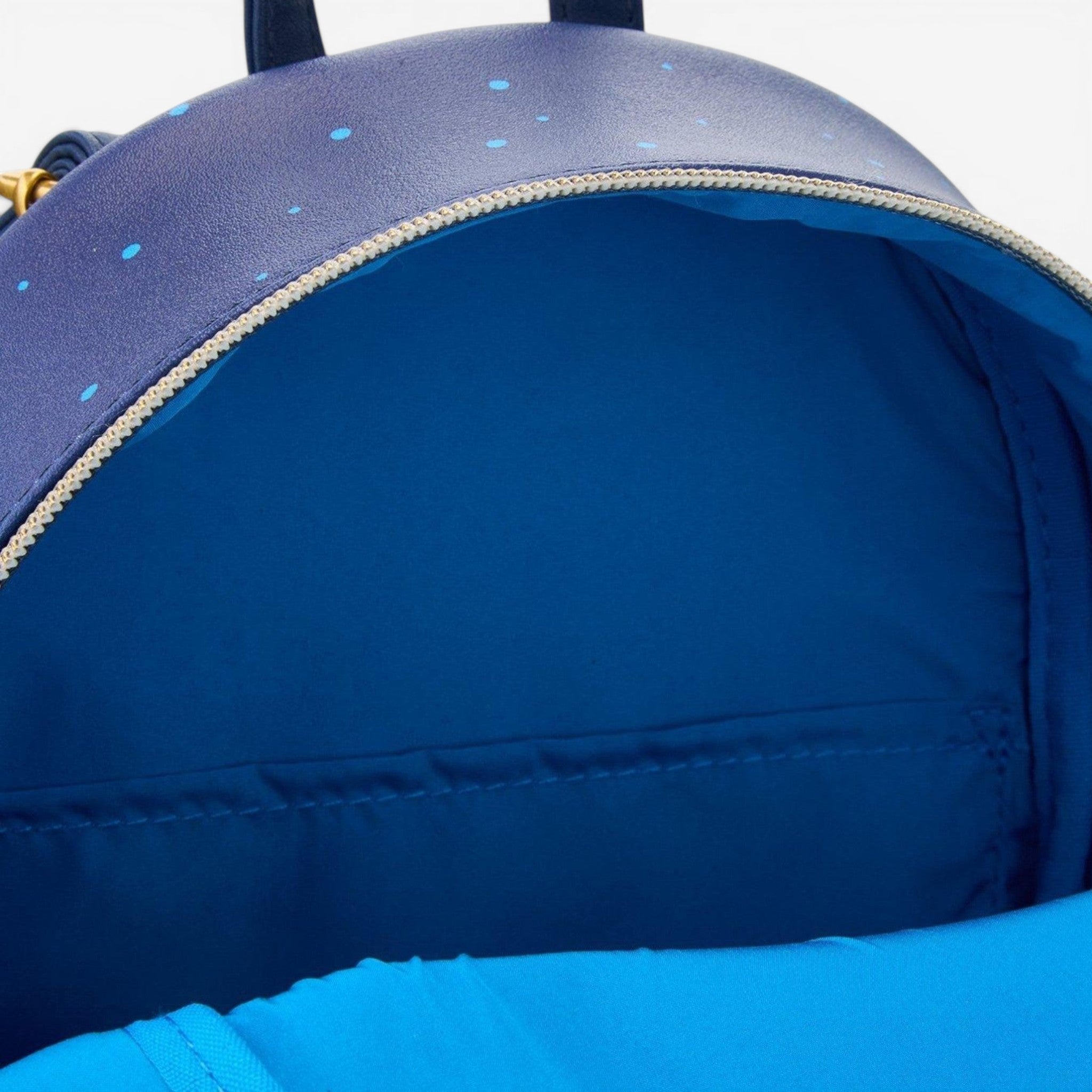 Once Upon Magic Disney Beauty and the Beast navy blue faux leather mini backpack with blue polka dots and interior pocket.