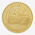Once Upon Magic gold-finish collectible medal featuring Lightning McQueen #95 and Disneyland Paris logo.