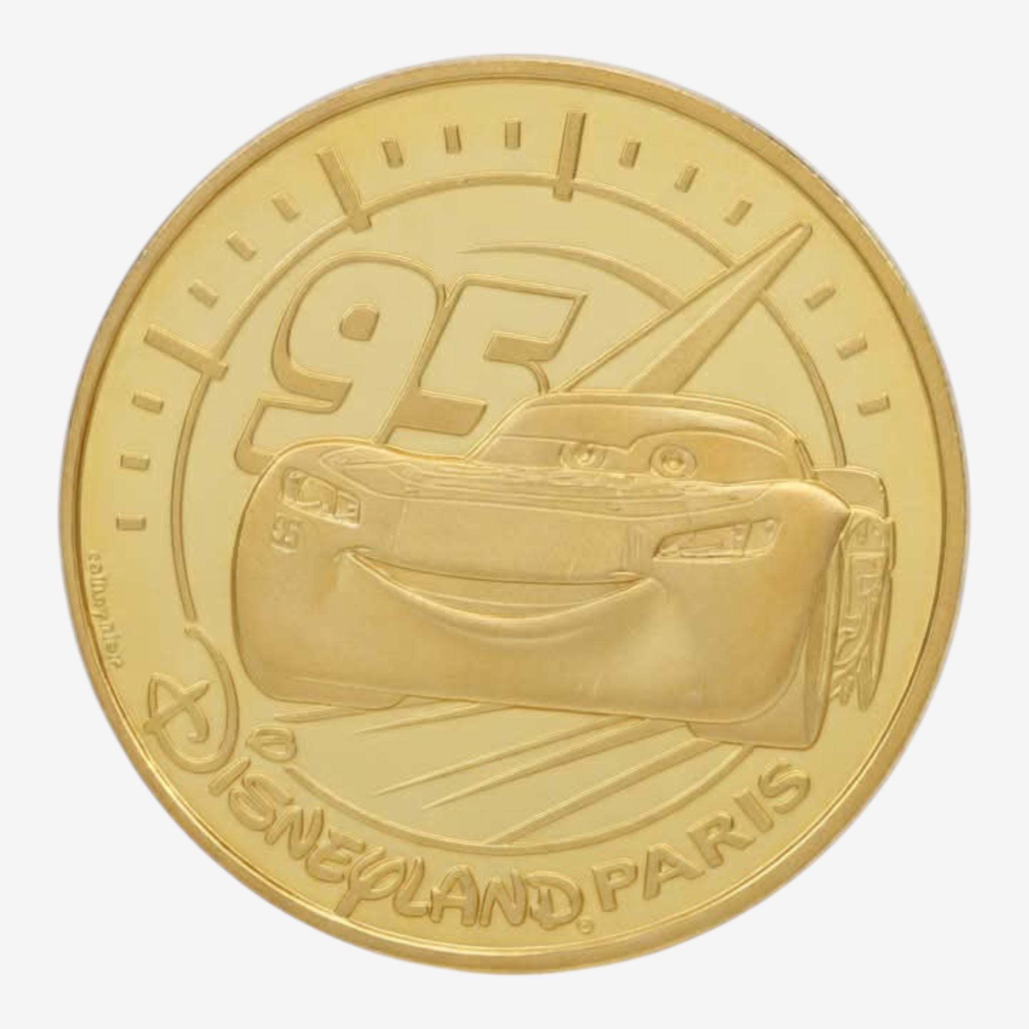 Once Upon Magic gold-finish collectible medal featuring Lightning McQueen #95 and Disneyland Paris logo.