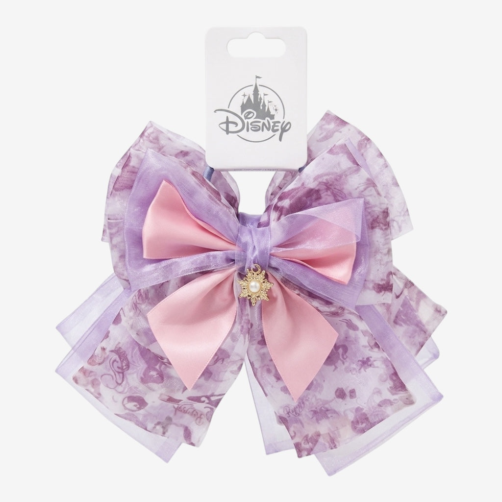 Once Upon Magic Disney Rapunzel bow with pastel purple and pink ribbons, floral print sheer overlay, and gold sun jewel.