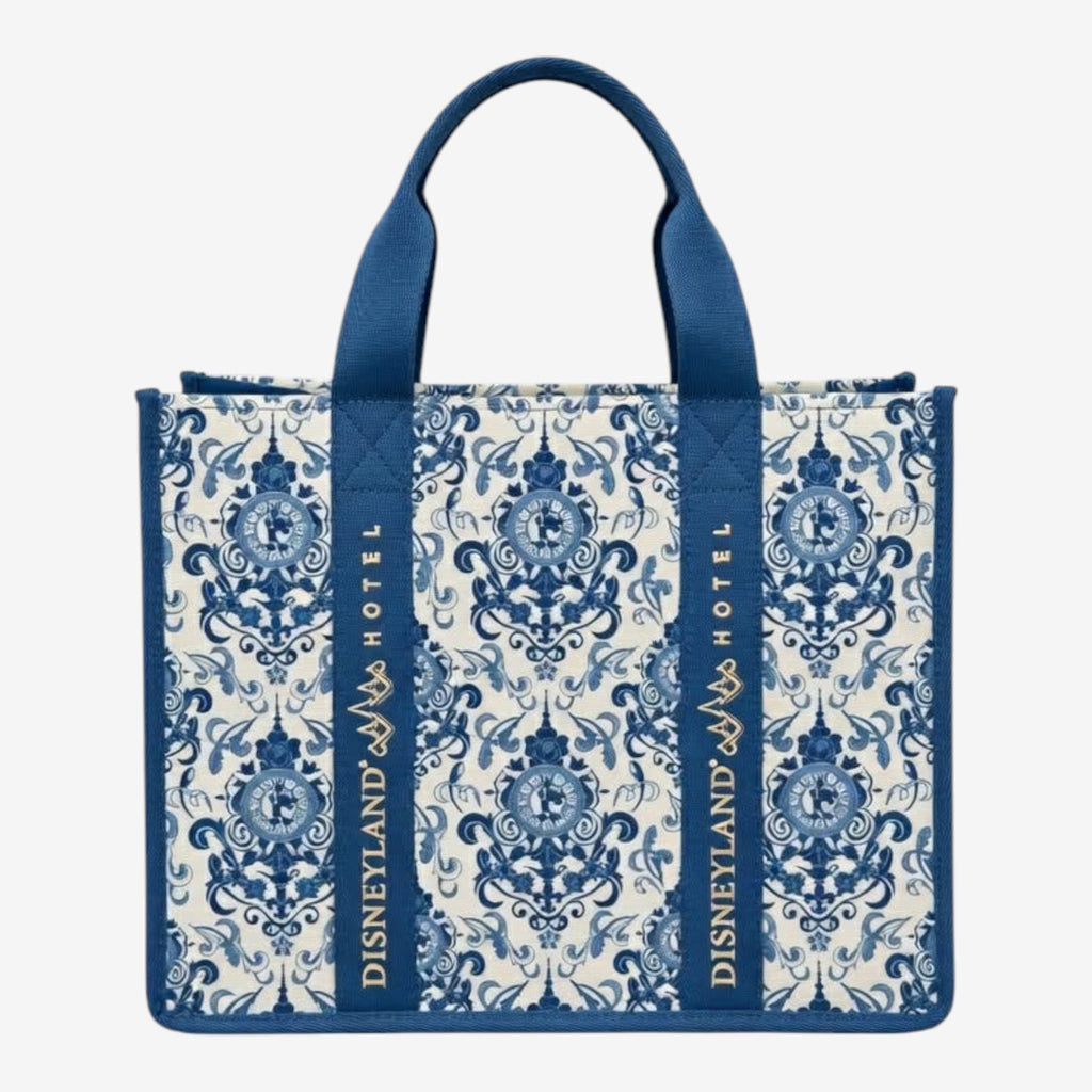 Once Upon Magic Disneyland Hotel tote bag in royal blue and white canvas with baroque floral motifs and Cinderella silhouette. Gold embroidered logo.