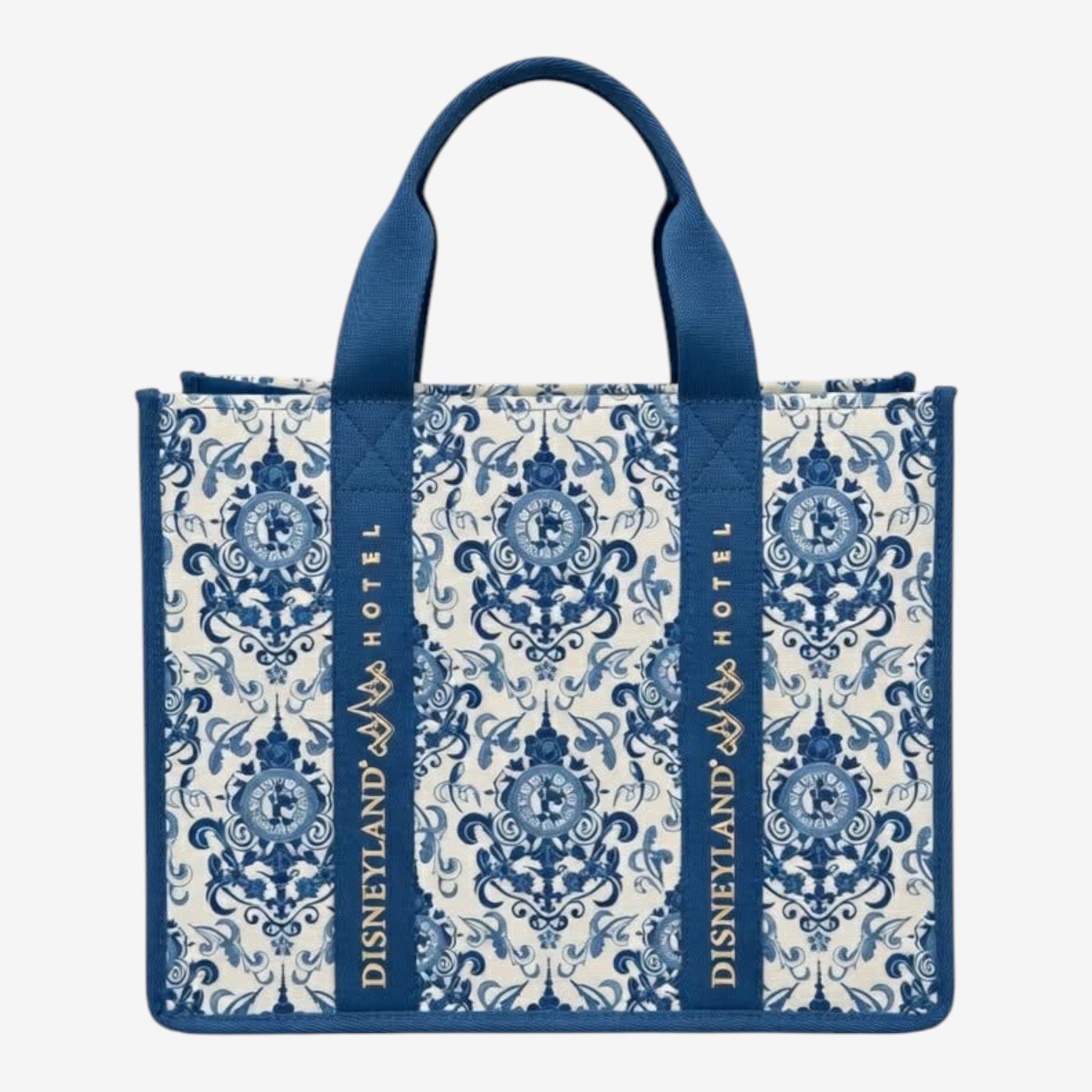 Once Upon Magic Disneyland Hotel tote bag in royal blue and white canvas with baroque floral motifs and Cinderella silhouette. Gold embroidered logo.
