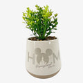 Once Upon Magic Disneyland Paris decorative plant in a white ceramic pot with Mickey ears and "HOME" design. Realistic green plant.