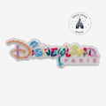 Once Upon Magic Disneyland Paris logo magnet with colorful, festive lettering and seasonal character motifs.