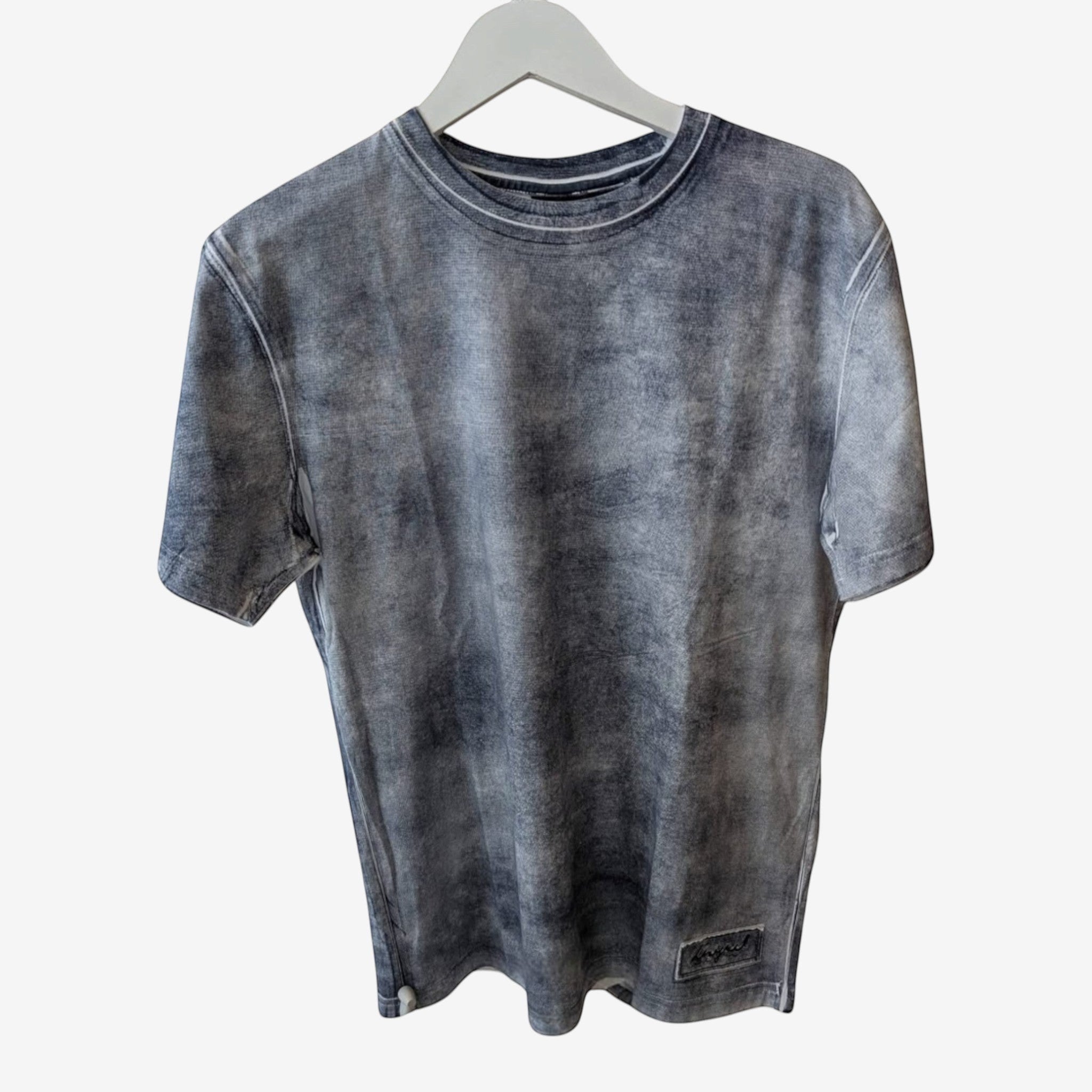 Once Upon Magic T-shirt in a distressed grey wash cotton. Short sleeves, crew neck, and a small embroidered logo patch on the hem.