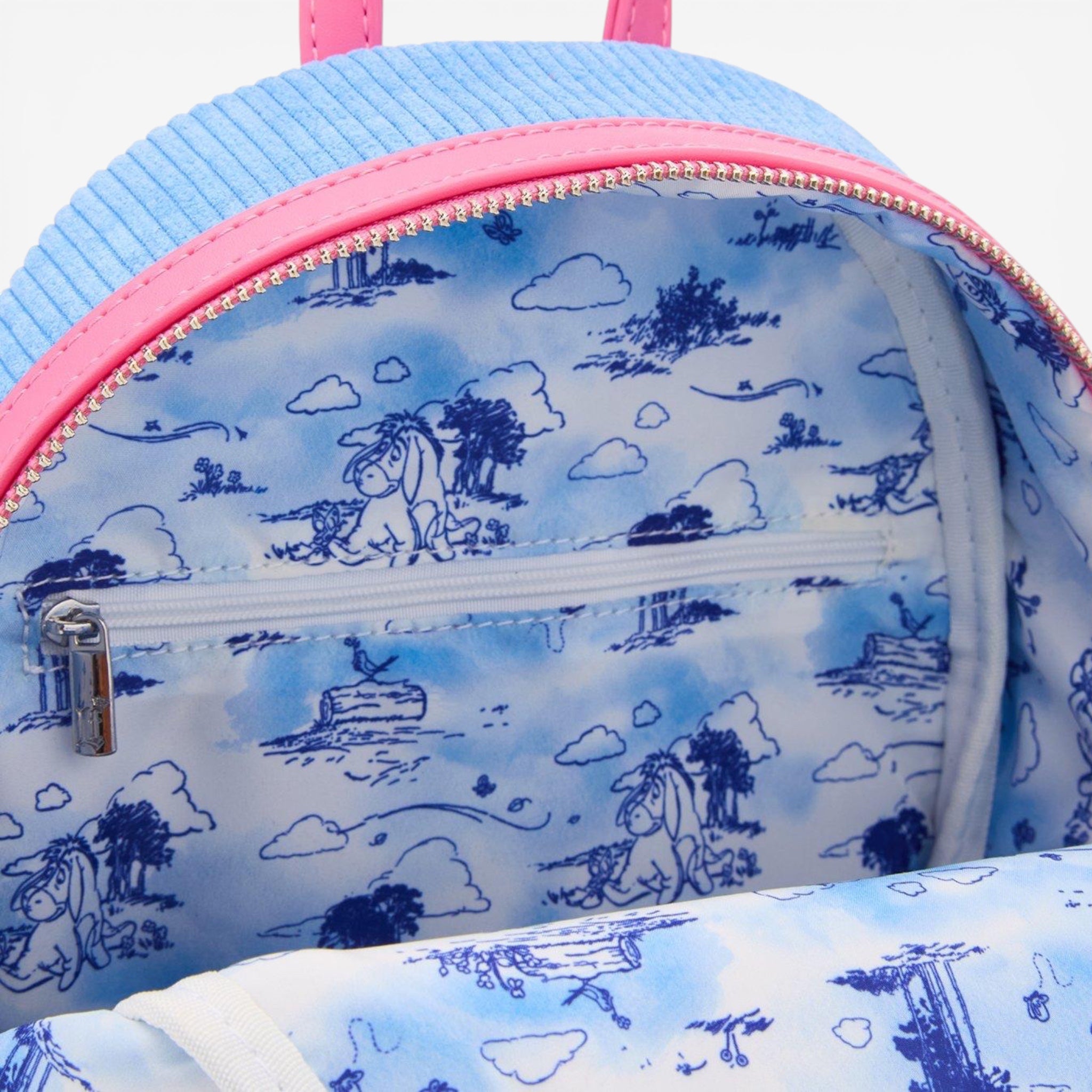 Once Upon Magic blue corduroy mini backpack with pink trim, featuring Eeyore print lining and magnetic ears.