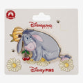 Once Upon Magic Disneyland Paris Eeyore enamel pin with cherries and daisies. Grey donkey with pink ribbon on tail.