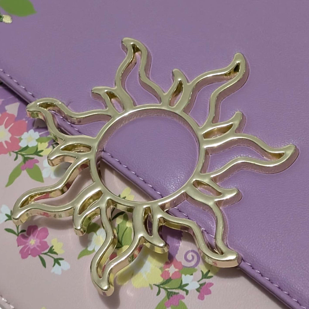 Once Upon Magic Floral Sun Crossbody Bag in lavender and pink with floral print and sun emblem. Features a silky scarf handle.