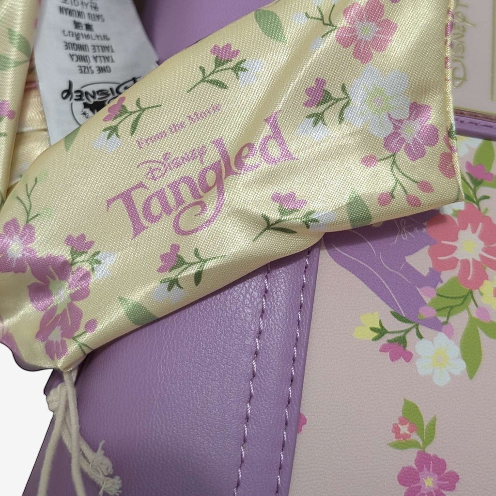 Once Upon Magic Floral Sun Crossbody Bag in lavender and pink with floral print and Tangled movie logo.