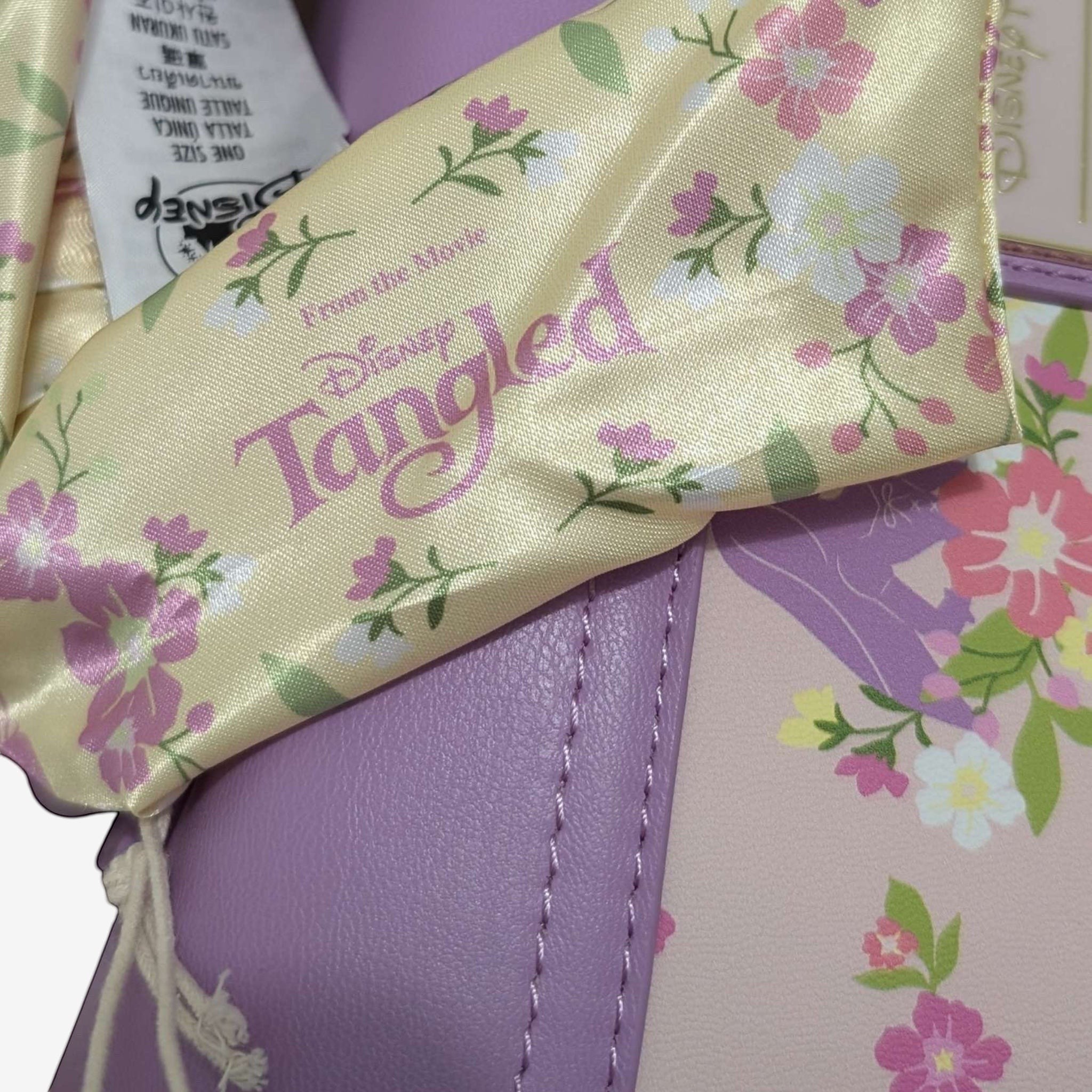 Once Upon Magic Floral Sun Crossbody Bag in lavender and pink with floral print and Tangled movie logo.