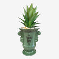 Once Upon Magic green ceramic planter with Phantom Manor text and faux succulent plant.