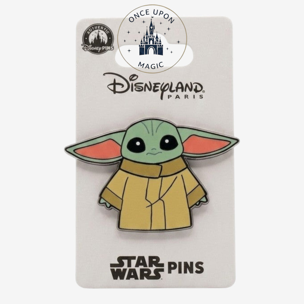 Once Upon Magic Star Wars Grogu enamel pin in cartoon style, wearing a tan robe. Features large ears and big eyes.