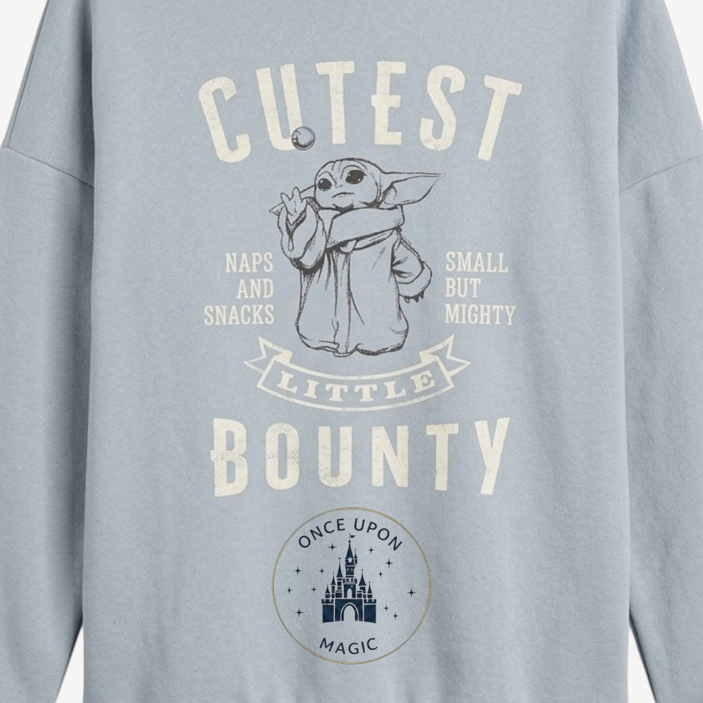 Once Upon Magic light blue crewneck sweatshirt with a graphic of Grogu from The Mandalorian and the text "Cutest Little Bounty".