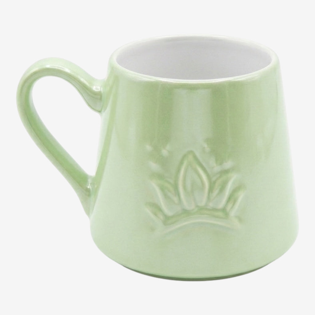 Once Upon Magic light green ceramic mug with embossed crown and inspirational quote inside. Comfortable handle, dishwasher and microwave safe.