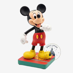 Once Upon Magic Mickey Mouse figurine in classic red shorts, yellow shoes, and black top. Detailed collectible on a colorful base.