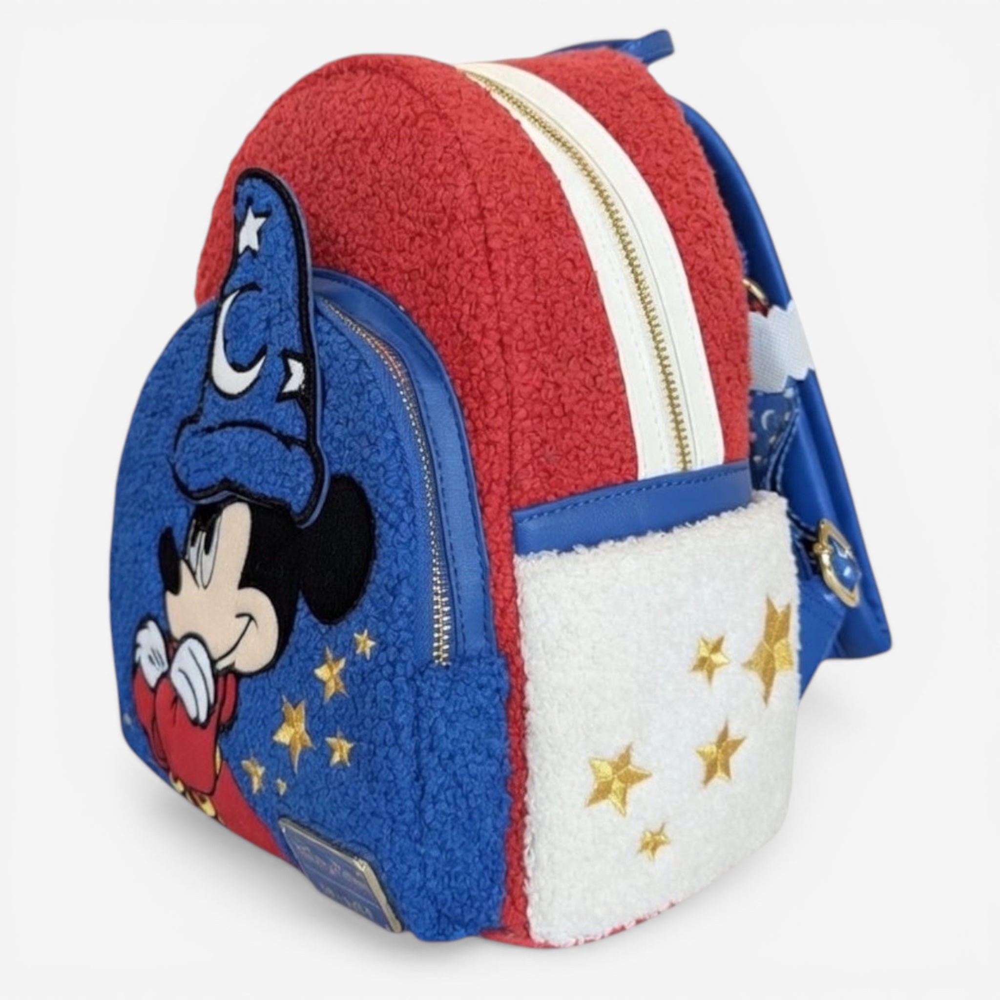 Once Upon Magic red, blue, and white fuzzy mini backpack with Mickey Mouse as the Sorcerer's Apprentice and gold stars.