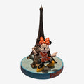 Once Upon Magic Minnie Eiffel Tower figurine with orange polka dot dress and bow, yellow shoes, on a blue base with Paris text.