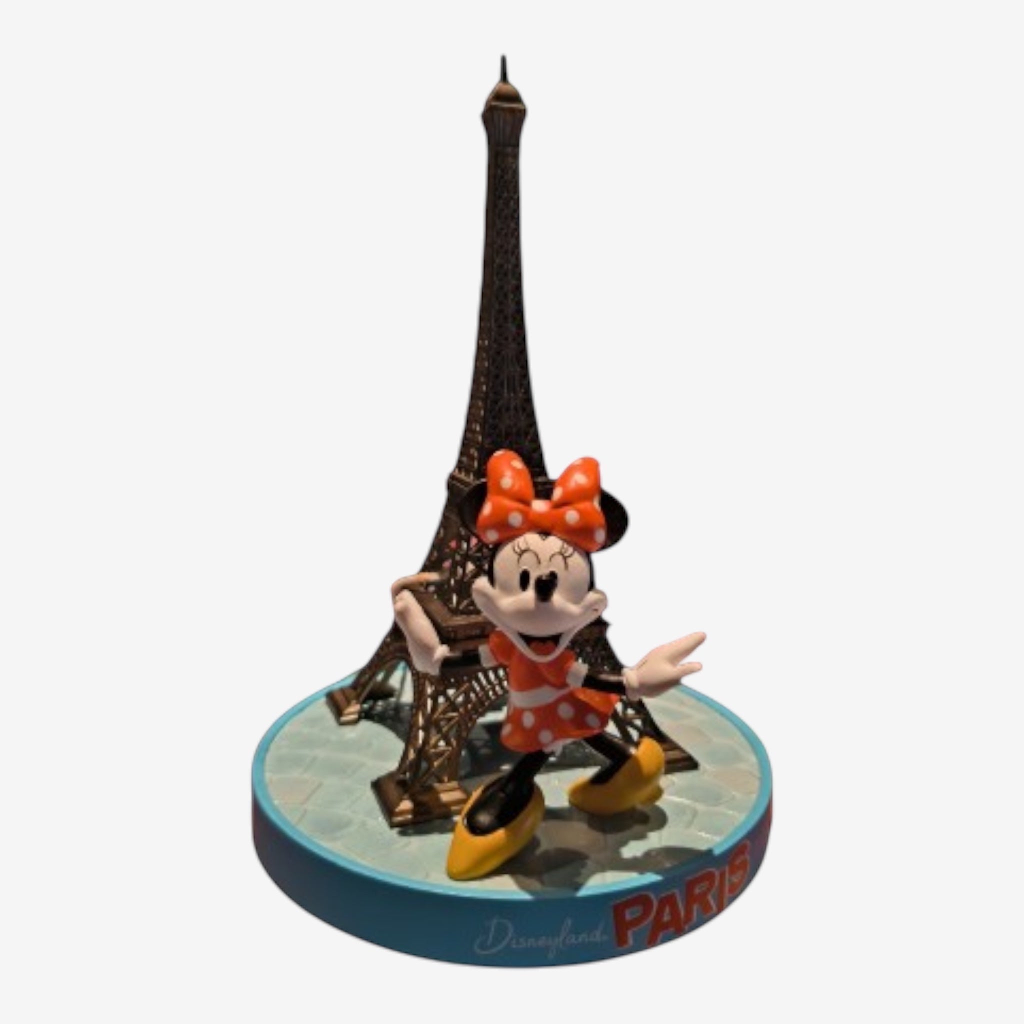 Once Upon Magic Minnie Eiffel Tower figurine with orange polka dot dress and bow, yellow shoes, on a blue base with Paris text.