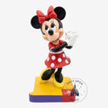 Once Upon Magic Minnie Mouse figurine in red polka-dot dress, yellow shoes, and red bow. Resin collectible.