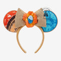 Once Upon Magic Moana-inspired Minnie ears with burlap bow, orange hibiscus flower, and "heart of Te Fiti" gem. Orange and blue ears with woven trim.