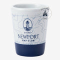 Once Upon Magic white ceramic Nespresso cup with navy blue base, featuring a nautical map design and Newport Bay Club logo with lighthouse.