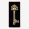 Once Upon Magic ornate brass key with decorative inlay and 'B' detail, presented in a red gift box with black velvet lining.