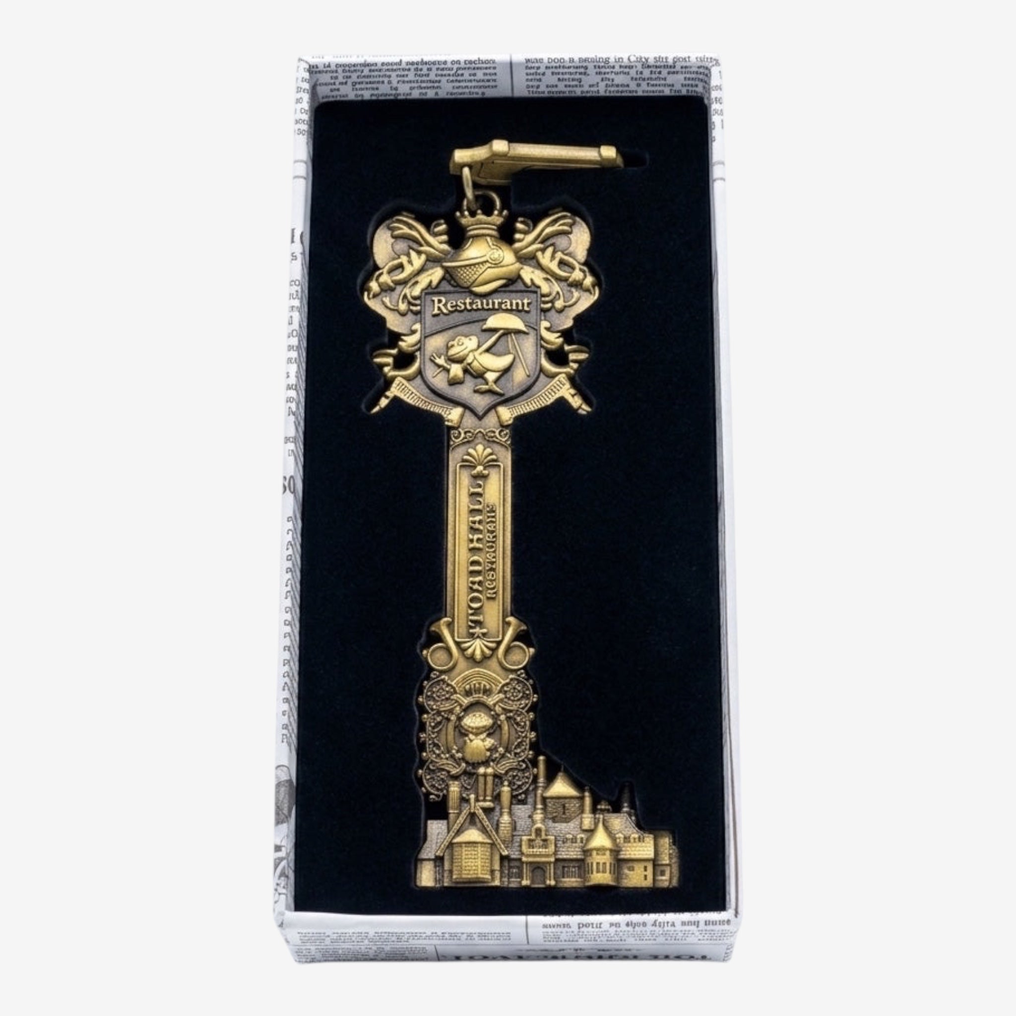 Once Upon Magic antique gold metal ornate castle key bottle opener with frog shield and "Toad Hall Restaurant" inscription.