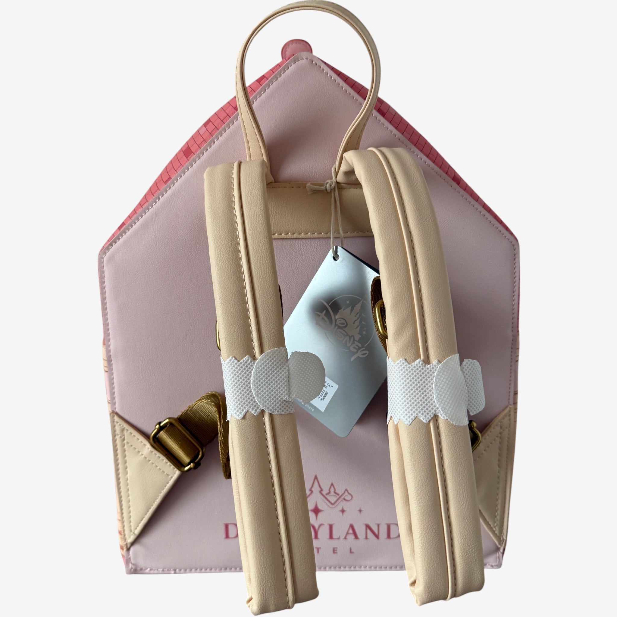 Once Upon Magic pink faux leather backpack shaped like a clock, featuring Mickey Mouse on the dial and Disneyland Hotel architecture details.
