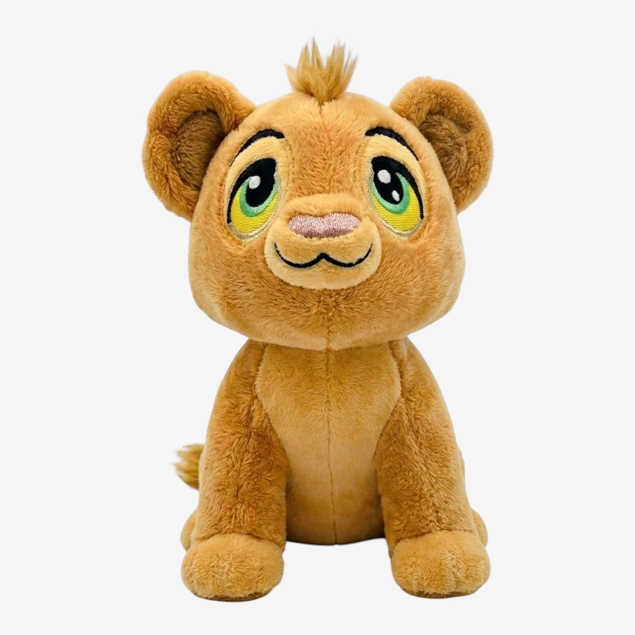 Once Upon Magic plush lion cub with golden-brown fur, expressive green eyes, and a tuft of hair. Soft and huggable.