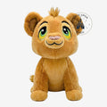 Once Upon Magic plush lion cub with golden-brown fur, expressive green eyes, and a tuft of hair. Soft and huggable.