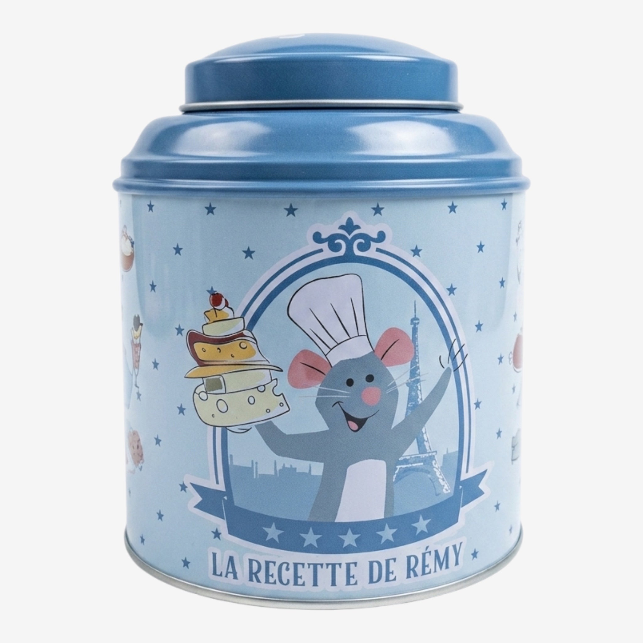 Once Upon Magic blue tin tea box featuring Remy from Ratatouille holding a stack of cheese and cake, with Eiffel Tower background.