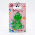 Once Upon Magic Disneyland Paris Rex Gummy pin, a translucent green enamel pin of the Toy Story dinosaur character sitting, with a pink backing card featuring candy graphics.