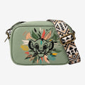 Once Upon Magic green faux leather crossbody bag featuring a Simba illustration with tribal-inspired foliage and a patterned strap.