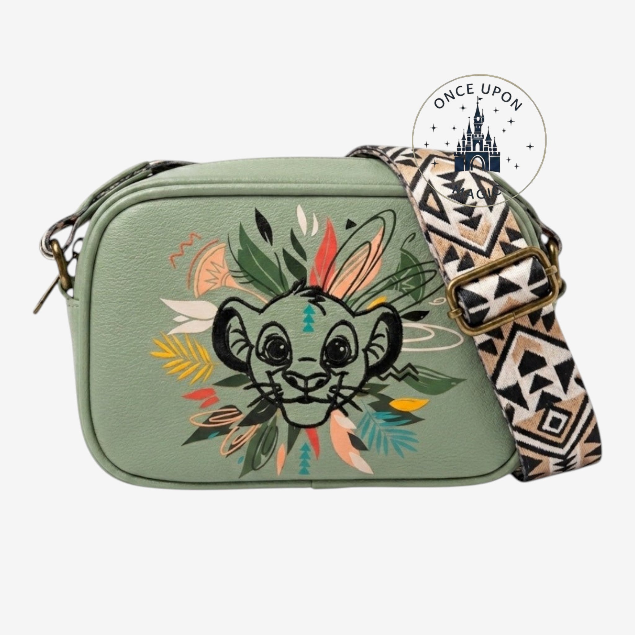 Once Upon Magic green faux leather crossbody bag featuring a Simba illustration with tribal-inspired foliage and a patterned strap.