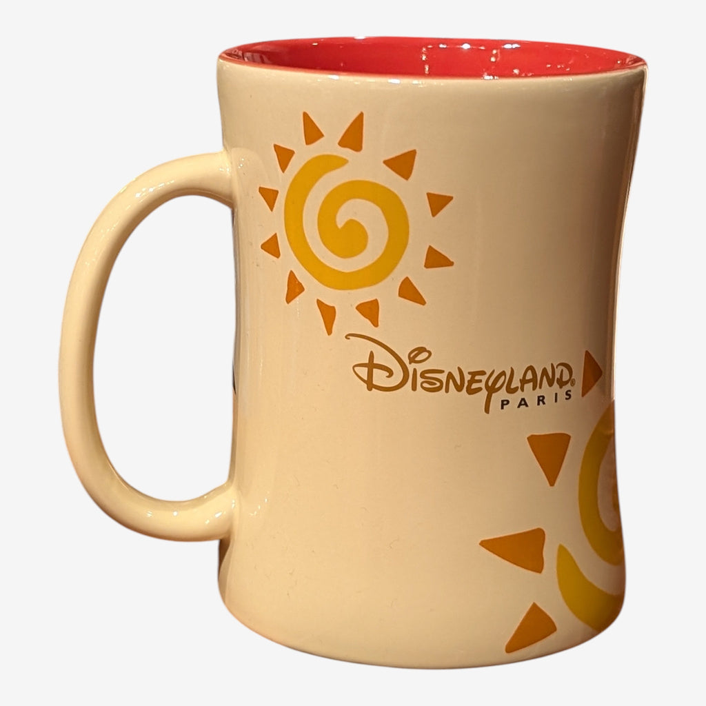 Once Upon Magic cream ceramic mug with Simba sun design and Disneyland Paris logo, red interior.