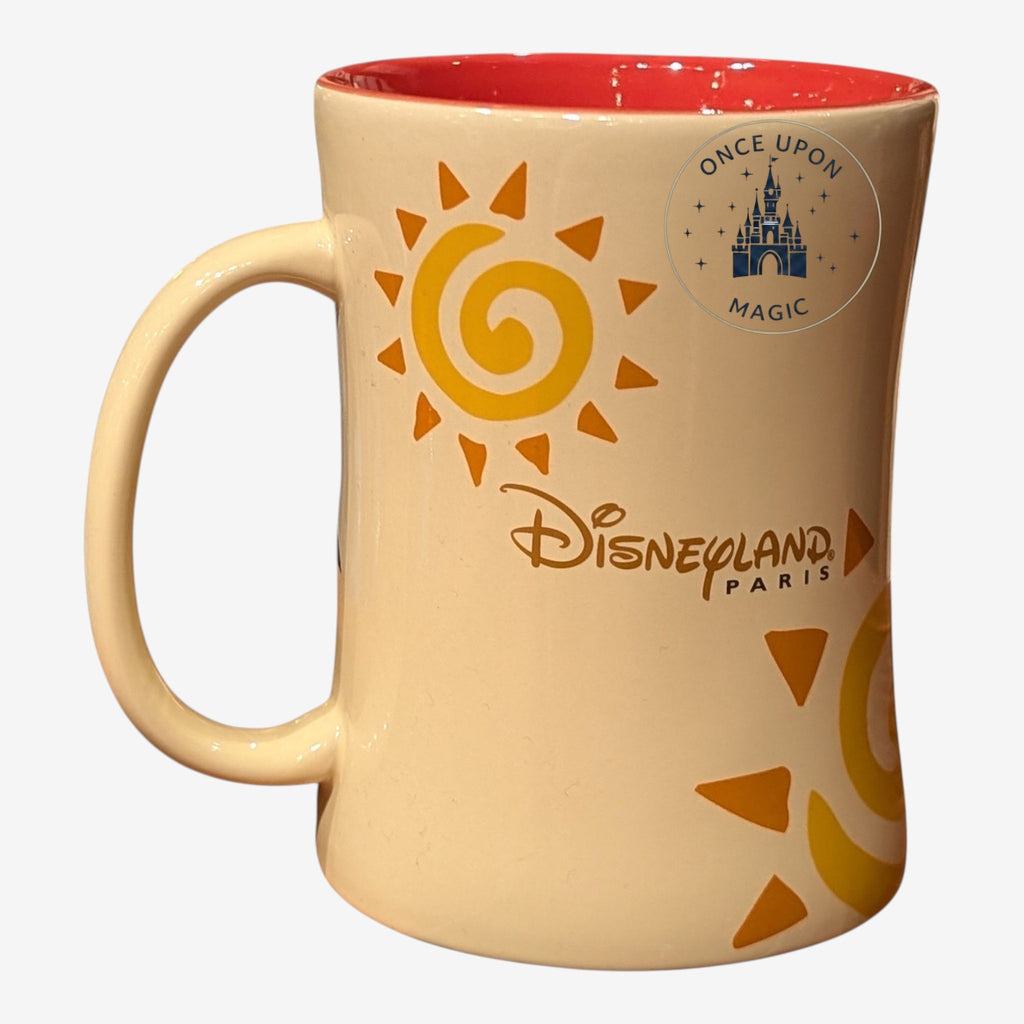 Once Upon Magic cream ceramic mug with Simba sun design and Disneyland Paris logo, red interior.