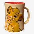 Once Upon Magic cream ceramic mug featuring a smiling Simba from The Lion King, with a red interior and sun-like patterns.