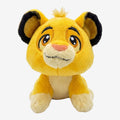 Once Upon Magic The Lion King Simba plush toy, vibrant yellow, soft huggable material, iconic playful expression, big eyes, mischievous smile.