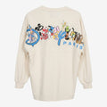 Spirit Jersey Disneyland Paris crème avec logo "Est. 1992" et personnages Disney au dos. Coupe ample et confortable.