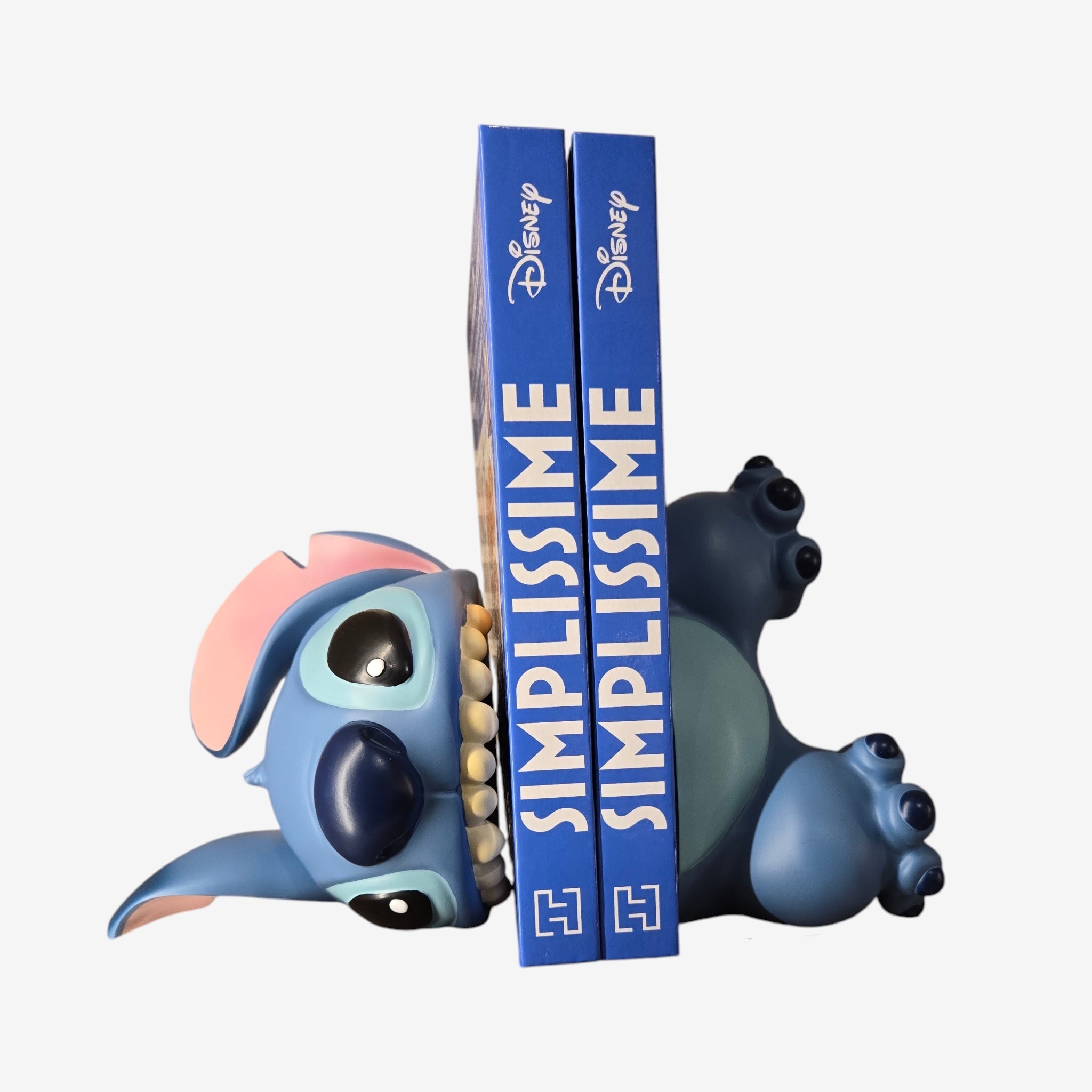 Once Upon Magic Disney Stitch bookend, blue resin, depicting Stitch lying down with a mischievous smile, holding books.