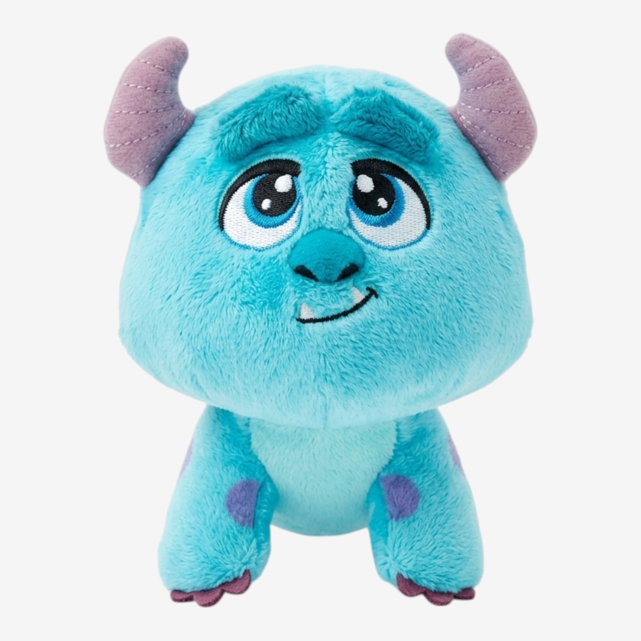 Once Upon Magic Sully plush toy from Monsters Inc. Blue with purple spots, soft plush material, embroidered eyes and horns.