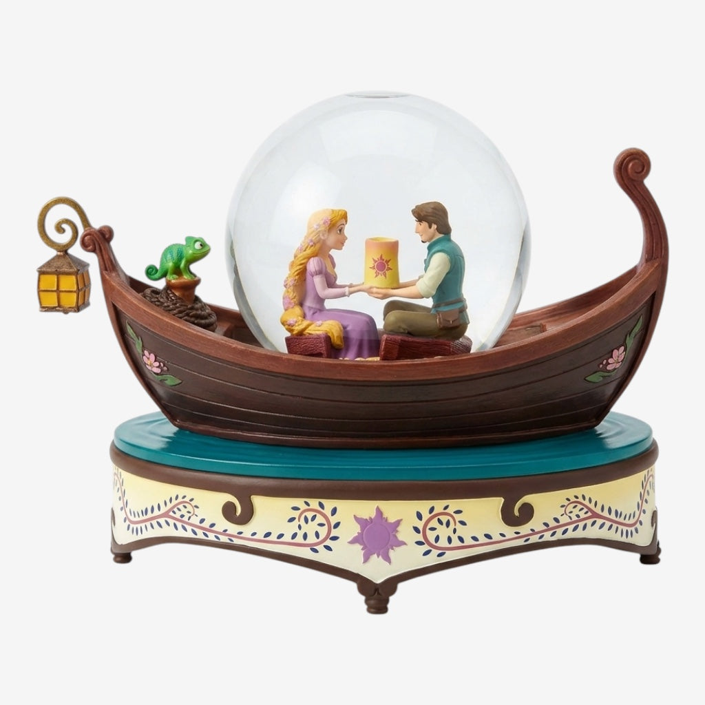 Once Upon Magic Tangled musical snow globe featuring Rapunzel and Flynn Rider in a boat with Pascal and a lantern. Plays "I See the Light".