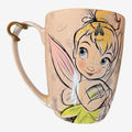 Once Upon Magic Tinker Bell mug with a pastel pink iridescent finish and a sketch-style illustration of the fairy.