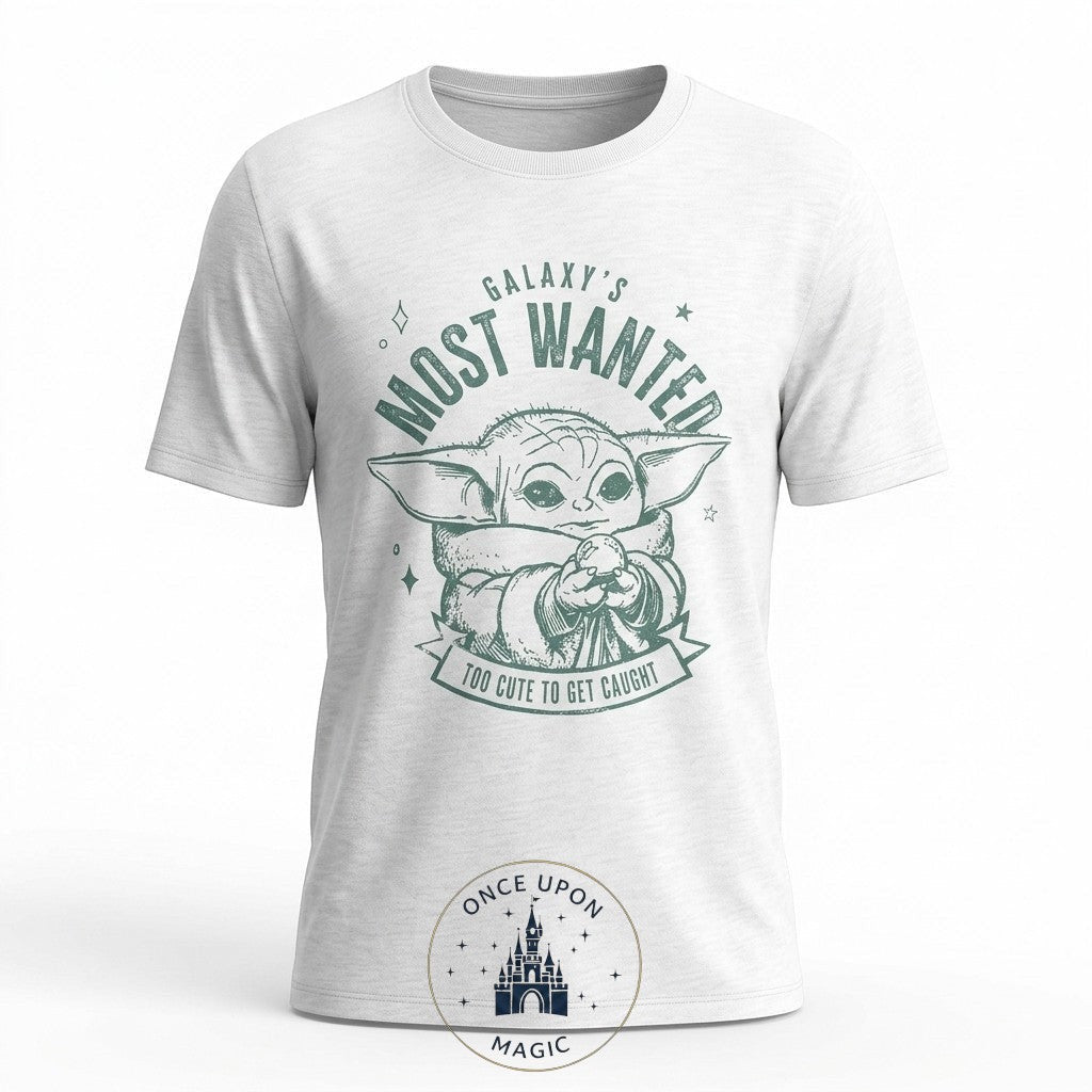 Once Upon Magic white cotton t-shirt with a green graphic of Grogu from Star Wars, reading "Galaxy's Most Wanted" and "Too Cute to Get Caught."