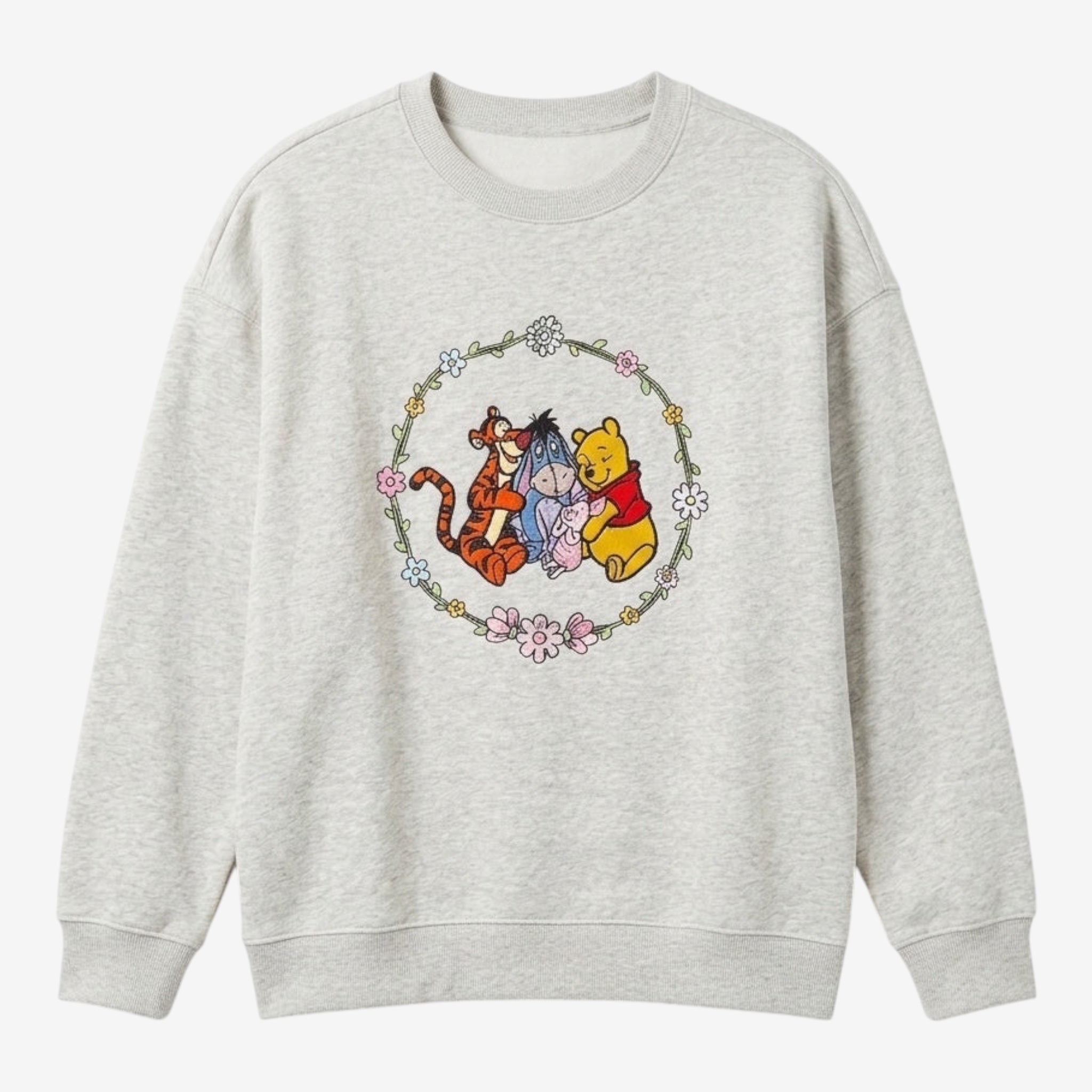 Once Upon Magic light grey crewneck sweatshirt with Winnie the Pooh, Tigger, Eeyore, and Piglet graphic in a floral wreath.